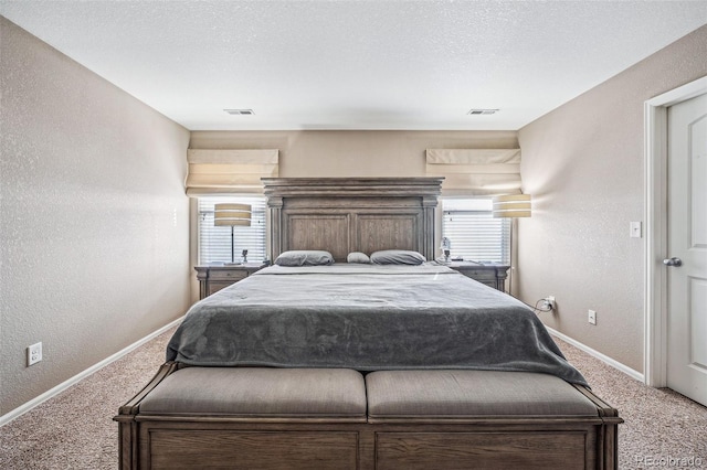 carpeted bedroom with a textured ceiling