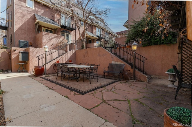 view of patio with stairs and outdoor dining space