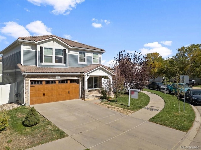 5555 Perth Ct, Denver, CO 80249 - view of front of home featuring a front lawn, driveway, stone siding, a tiled roof, and a garage