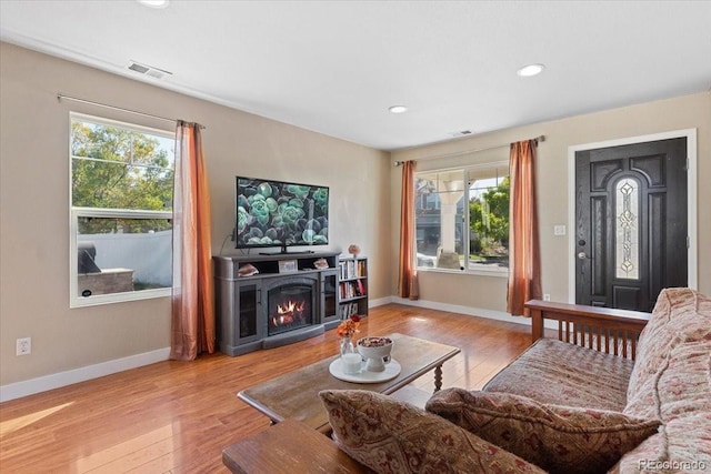 5555 Perth Ct, Denver, CO 80249 - living area featuring plenty of natural light, visible vents, and wood finished floors