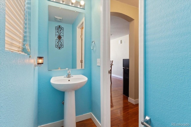 5555 Perth Ct, Denver, CO 80249 - bathroom with a sink, visible vents, baseboards, wood finished floors, and a textured wall