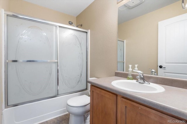 full bathroom with toilet, vanity, and combined bath / shower with glass door