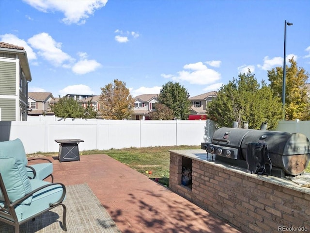 view of patio featuring a grill