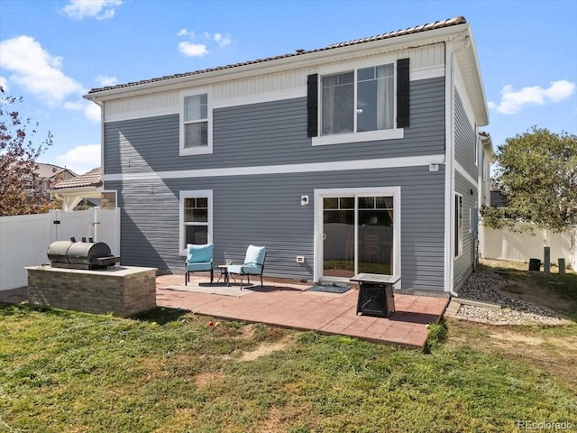 back of house with a patio area, a lawn, and a fire pit