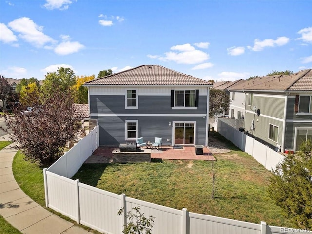 5555 Perth Ct, Denver, CO 80249 - rear view of property with a fenced backyard, a patio, a yard, and a tiled roof