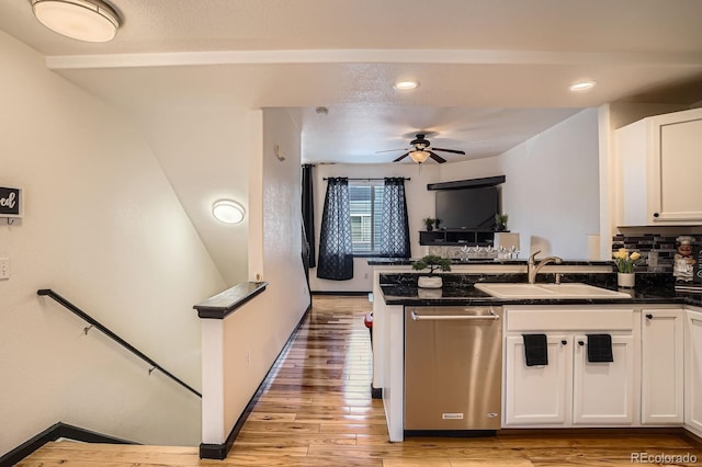 8751 Pearl St Unit J3, Thornton, CO 80229 - kitchen featuring stainless steel dishwasher, a peninsula, white cabinets, light wood-style floors, and open floor plan