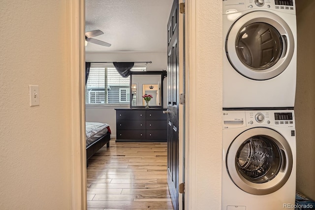 8751 Pearl St Unit J3, Thornton, CO 80229 - laundry room with estacked washer and dryer and light wood-style flooring