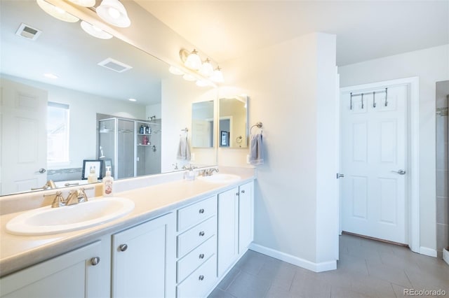 bathroom with vanity and a shower with shower door