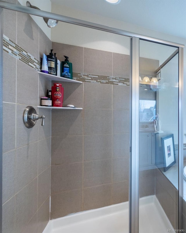 bathroom featuring a shower with shower door