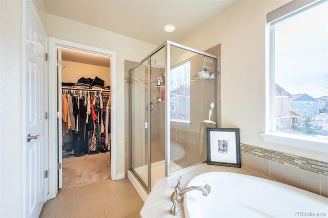 bathroom with tile patterned flooring and independent shower and bath