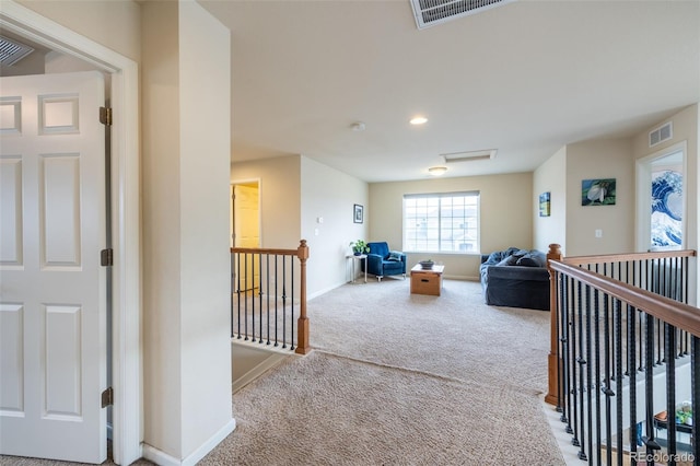 hallway with carpet floors