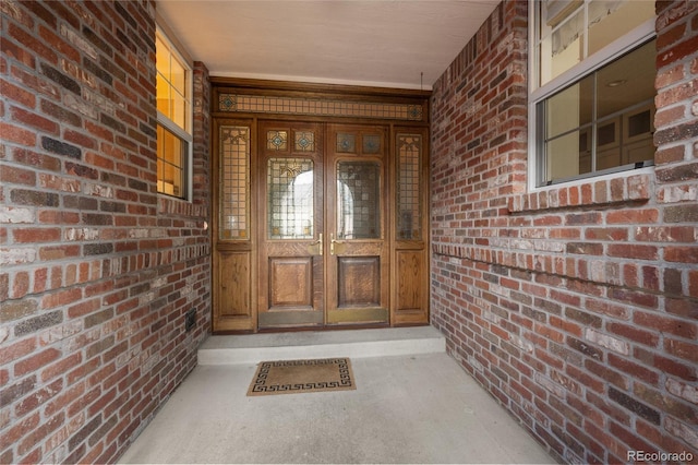 view of exterior entry featuring covered porch and french doors