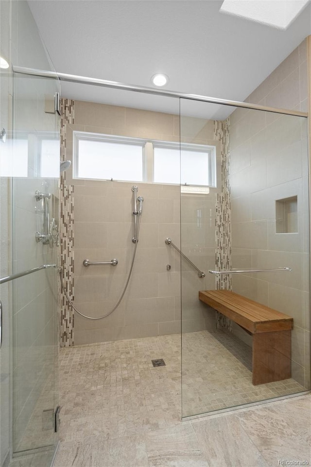 bathroom with a shower with door