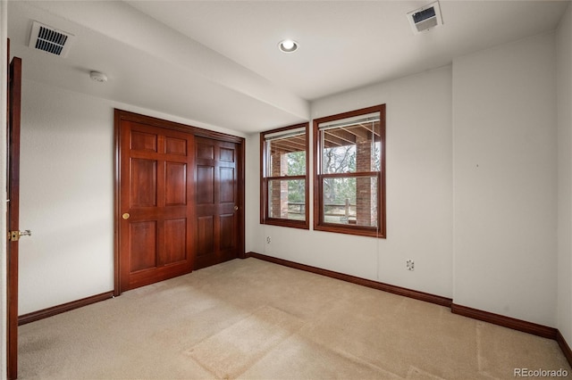 unfurnished bedroom featuring light carpet