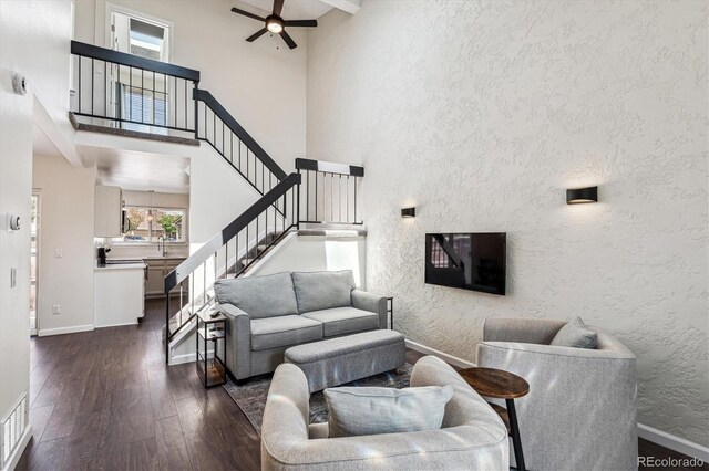 10309 W Fair Ave Unit E, Littleton, CO 80127 - living room with dark wood finished floors, a textured wall, baseboards, a ceiling fan, and stairs