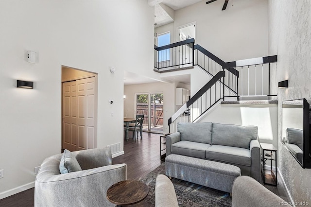 10309 W Fair Ave Unit E, Littleton, CO 80127 - living area with a towering ceiling, wood finished floors, stairway, baseboards, and a ceiling fan