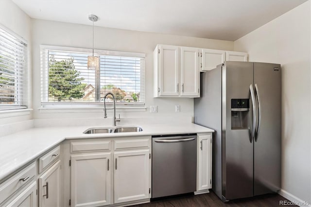 10309 W Fair Ave Unit E, Littleton, CO 80127 - kitchen featuring stainless steel appliances, a sink, white cabinetry, and light countertops