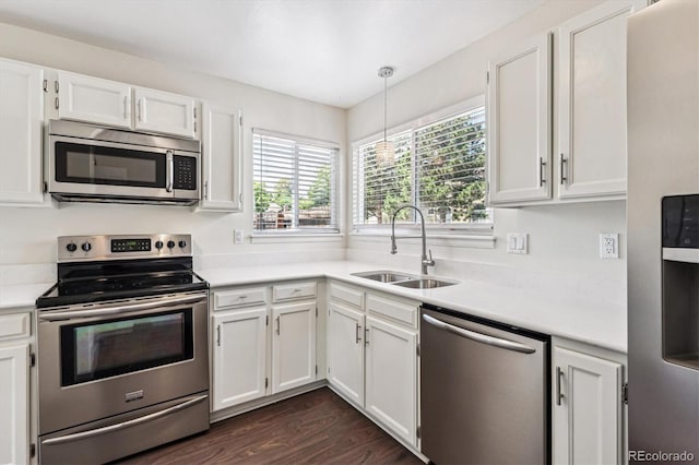 10309 W Fair Ave Unit E, Littleton, CO 80127 - kitchen with stainless steel appliances, a sink, light countertops, and white cabinets