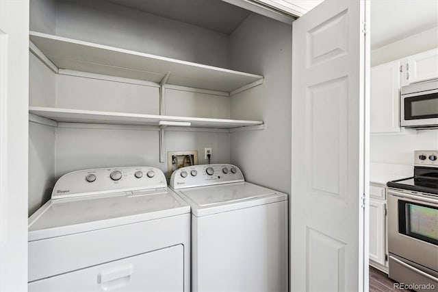 10309 W Fair Ave Unit E, Littleton, CO 80127 - washroom featuring washing machine and clothes dryer and dark wood-type flooring