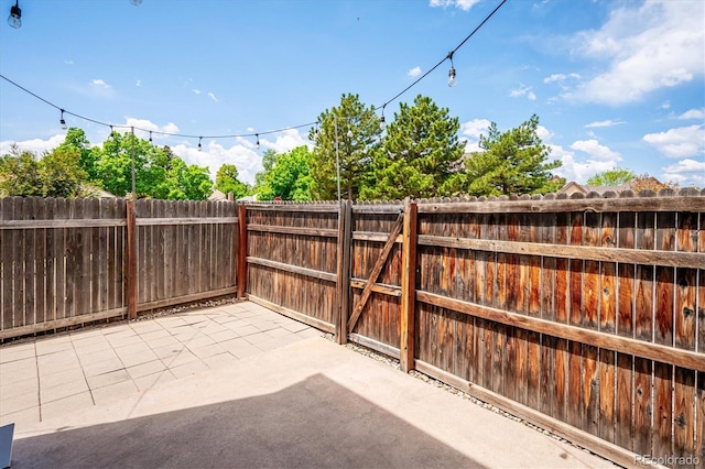 10309 W Fair Ave Unit E, Littleton, CO 80127 - fenced backyard featuring a patio