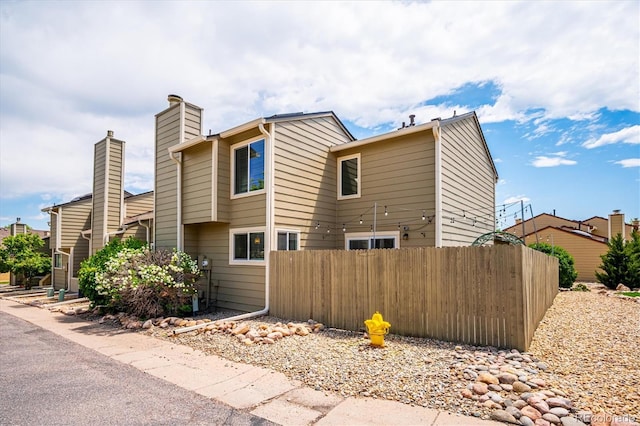 10309 W Fair Ave Unit E, Littleton, CO 80127 - view of home's exterior featuring a chimney