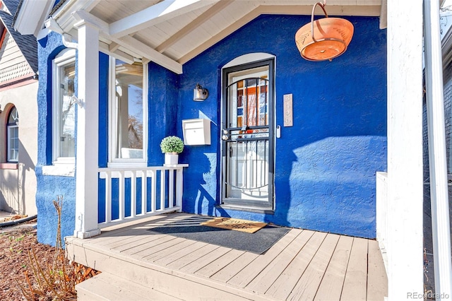 entrance to property featuring stucco siding