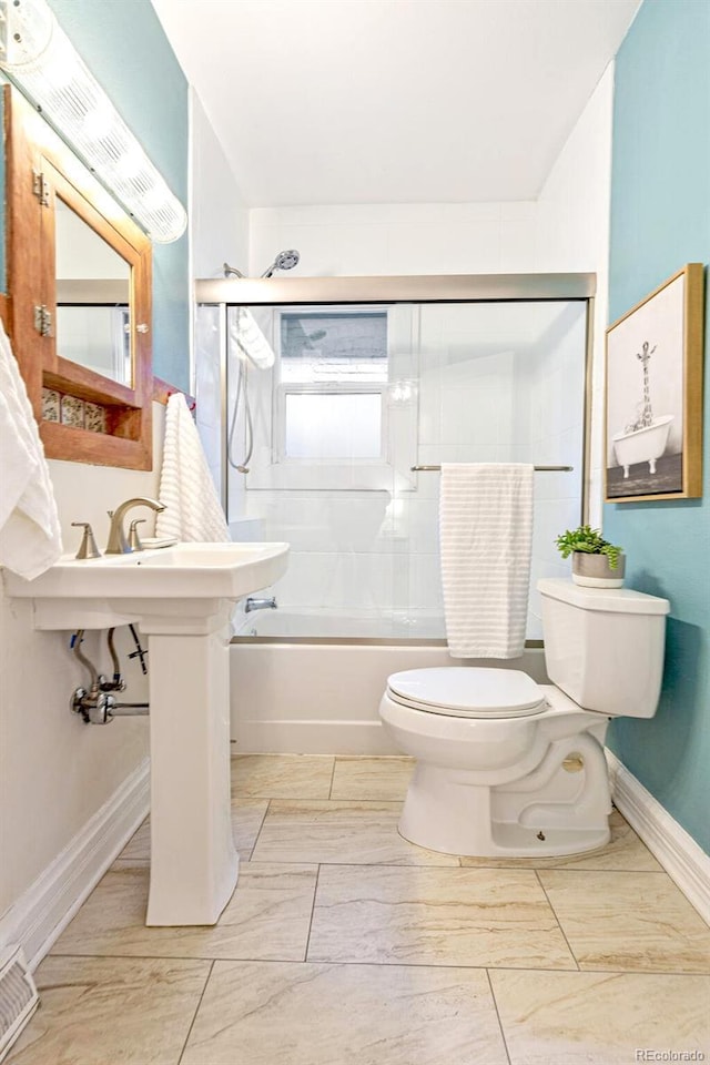 bathroom with toilet, shower / bath combination with glass door, baseboards, and visible vents