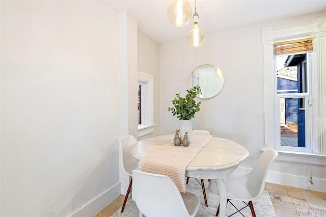 dining room featuring light tile patterned floors and baseboards