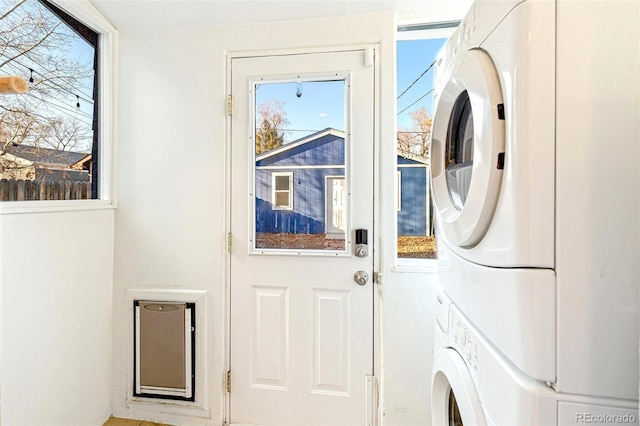 washroom featuring laundry area and stacked washer / dryer