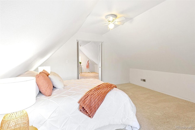 bedroom featuring carpet floors, lofted ceiling, visible vents, and ceiling fan