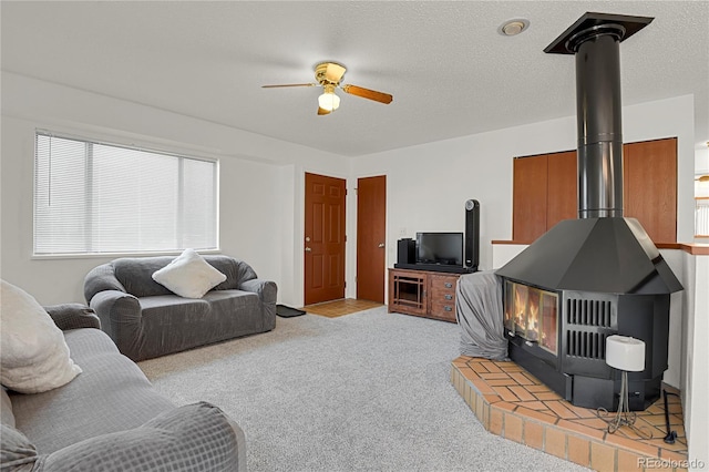 5501 Denmark Ct, Colorado Springs, CO 80918 - living area featuring a wood stove, ceiling fan, and light carpet