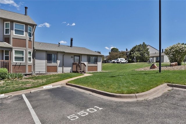 5501 Denmark Ct, Colorado Springs, CO 80918 - exterior space with uncovered parking, a front lawn, and roof with shingles