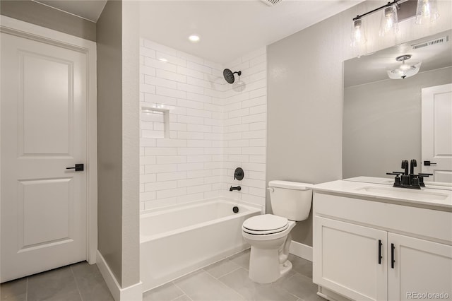 full bathroom with tile patterned flooring, vanity, tiled shower / bath combo, and toilet