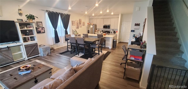 living room with stairway and wood finished floors