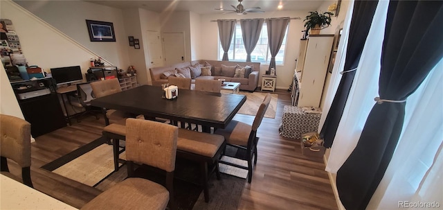 dining space featuring wood finished floors and ceiling fan