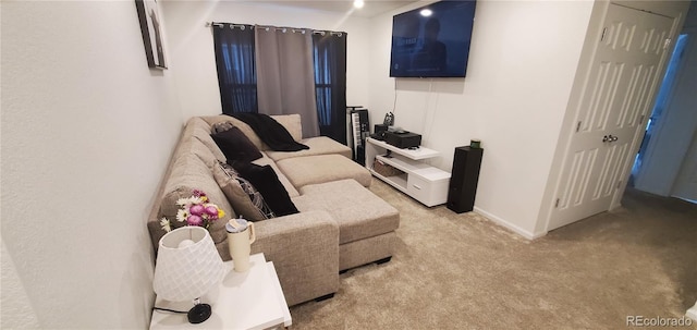 living area featuring baseboards and light colored carpet