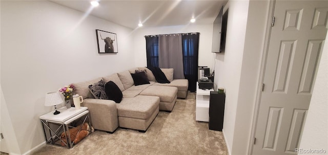 living area with recessed lighting and light carpet