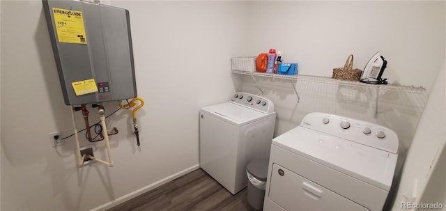 clothes washing area with dark wood-type flooring, separate washer and dryer, tankless water heater, baseboards, and laundry area