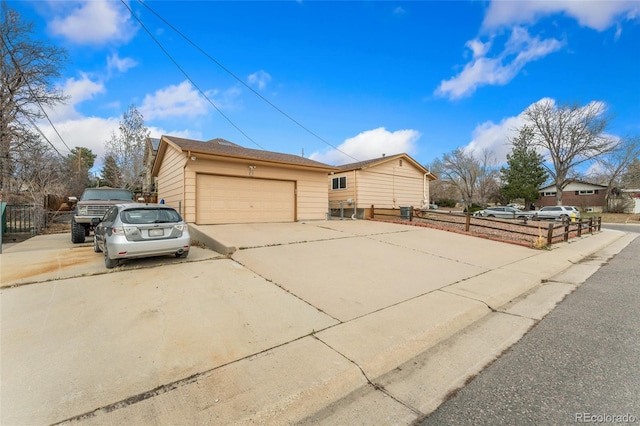 6545 Union St, Arvada, CO 80004 - view of home's exterior featuring concrete driveway, fence, and an outdoor structure