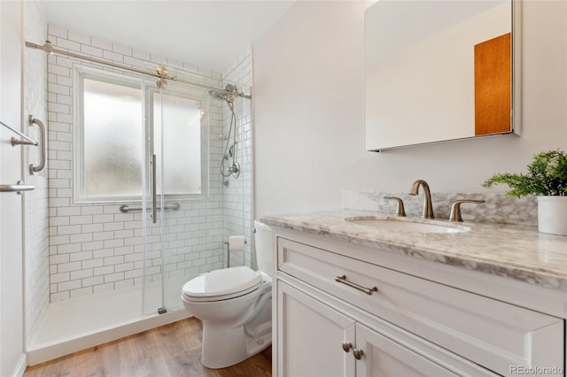 6545 Union St, Arvada, CO 80004 - bathroom featuring vanity, a shower stall, toilet, and wood finished floors