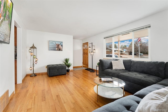 6545 Union St, Arvada, CO 80004 - living room featuring baseboards, visible vents, and light wood-style flooring