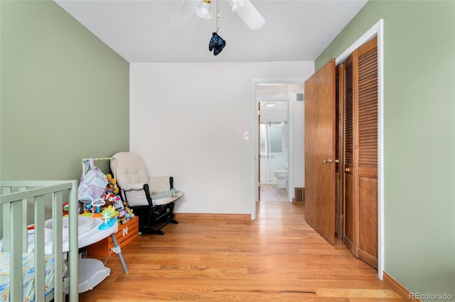 6545 Union St, Arvada, CO 80004 - bedroom with a ceiling fan, a crib, light wood finished floors, and a closet