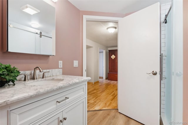 6545 Union St, Arvada, CO 80004 - bathroom featuring vanity and wood finished floors