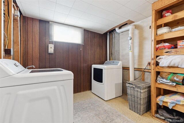 6545 Union St, Arvada, CO 80004 - laundry area with wood walls and washer and clothes dryer