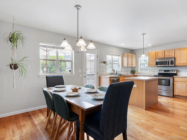 8450 E 29th Ave, Denver, CO 80238 - dining space with light wood finished floors, a chandelier, and recessed lighting