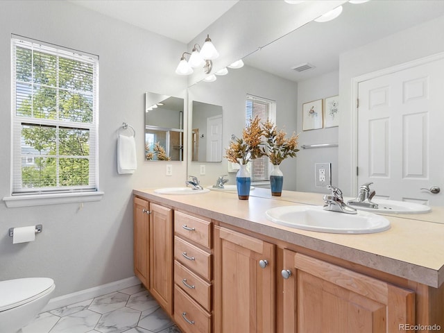 8450 E 29th Ave, Denver, CO 80238 - bathroom featuring double vanity and marble finish flooring