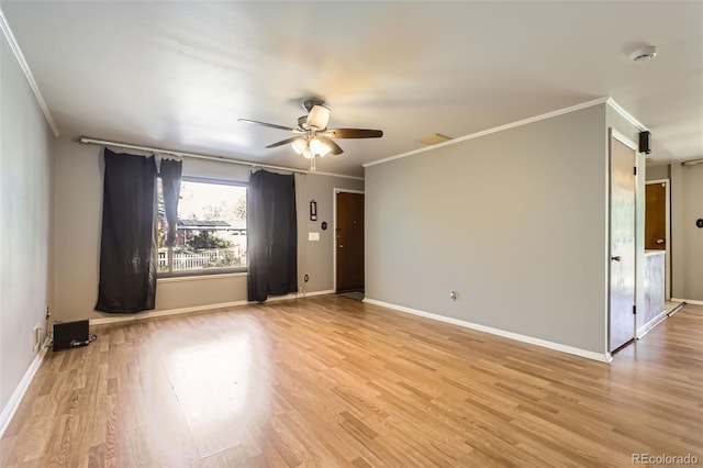 empty room featuring light hardwood / wood-style flooring, ceiling fan, and crown molding