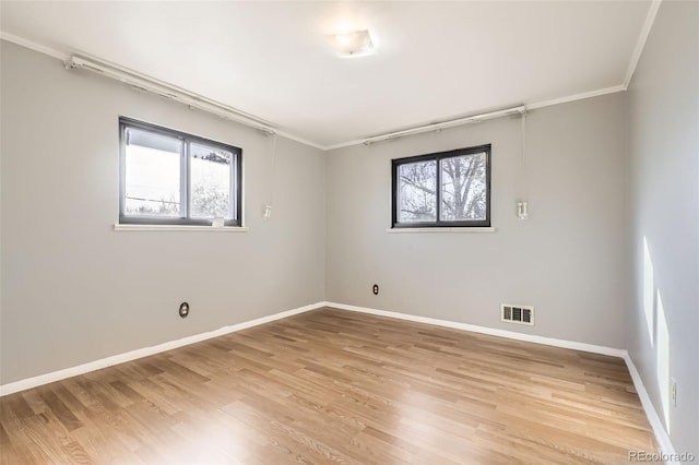 unfurnished room featuring light hardwood / wood-style flooring and ornamental molding