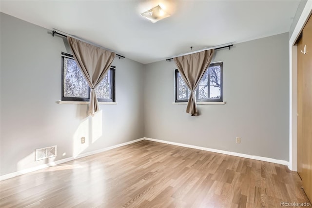 spare room featuring light hardwood / wood-style floors