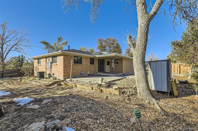 rear view of property featuring central AC unit and a patio area